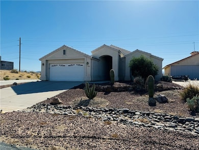 Ranch-style home featuring an attached garage, con