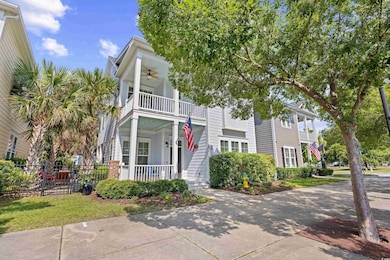 View of front of property featuring a balcony, covered porch, and ceiling fan