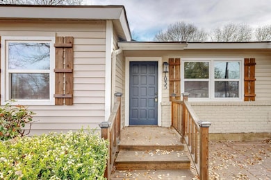 Doorway to property featuring brick siding