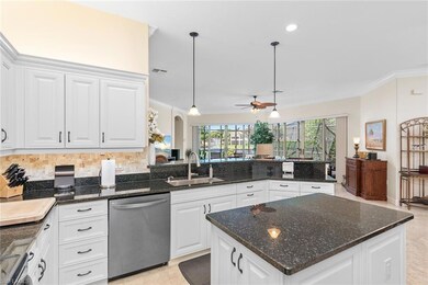 Kitchen featuring white cabinetry, appliances with stainless steel finishes, pendant lighting, sink, and kitchen peninsula