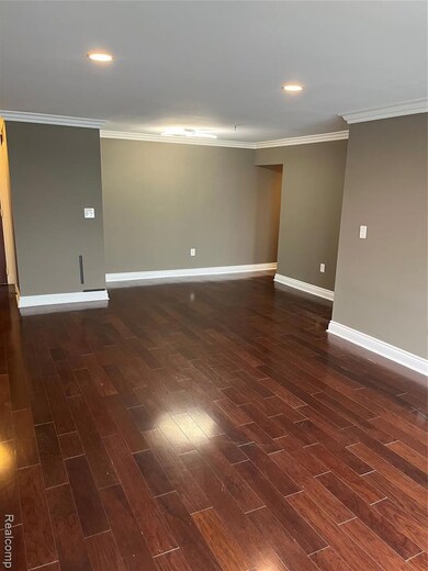 Unfurnished room featuring ornamental molding, dark wood finished floors, and recessed lighting