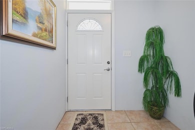 Doorway with light tile patterned floors