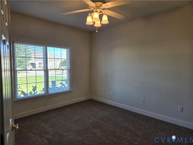 Secondary bedroom located at front of home showing now with furniture removed. Great space for guests with access to full, hall bath.