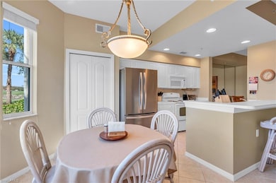 Dining space featuring light tile patterned floori