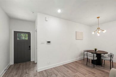 The sleek front door, accentuated by window and cl