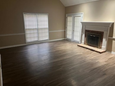 Unfurnished living room featuring dark wood-type f