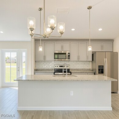 Kitchen with backsplash, a spacious island, stainless steel appliances, recessed lighting, and wood finish floors