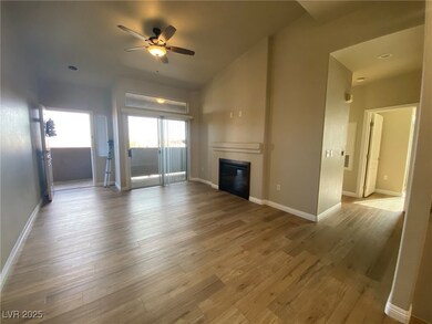 Unfurnished living room with a ceiling fan, a glas