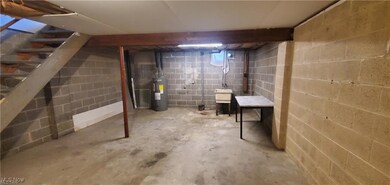 Unfinished basement featuring water heater