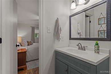Bathroom featuring LVP, ensuite bath, and vanity