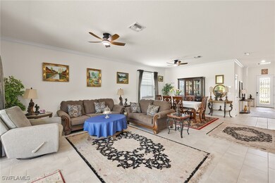 Living area featuring ceiling fan, crown molding,