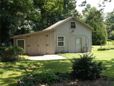 Wired workshop for the DIY, handyman. Small slab patio on back and front of workshop. Loft storage in the upstairs.