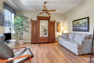 Living room featuring a ceiling fan, baseboards, a