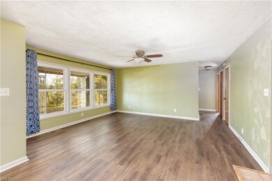 Empty room featuring a textured ceiling, dark hard