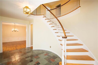Stairway featuring light tile flooring