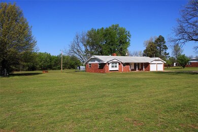 Ranch-style house with a garage, a front lawn, and