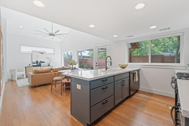 Kitchen featuring a sink, visible vents, gray cab