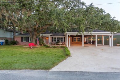 Large carport and larger driveway with landscape l