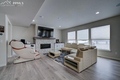 Living room with a textured ceiling, light hardwoo