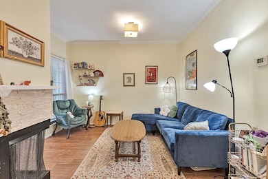 Living area with wood finished floors, ornamental