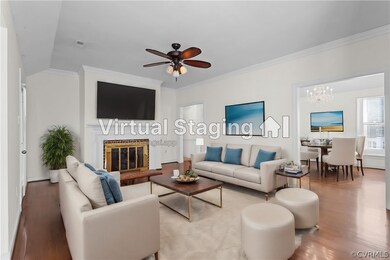 Living room featuring crown molding, ceiling fan w