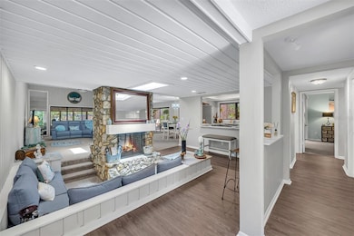 Living Space with 2 sided stone wood burning fireplace &