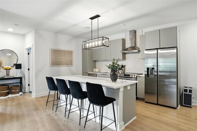 Kitchen featuring stainless steel fridge, wall ch