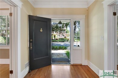 The entry hall is broad and deep, with a view from