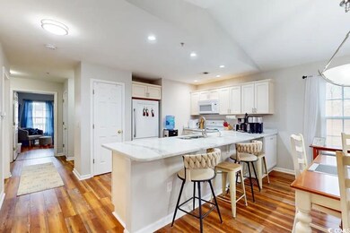 Kitchen with kitchen peninsula, white appliances, 