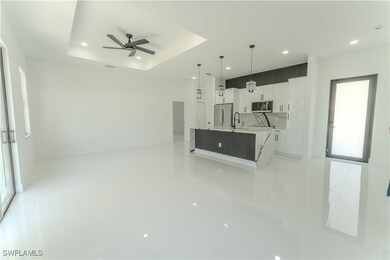 Unfurnished living room with a sink, ceiling fan,