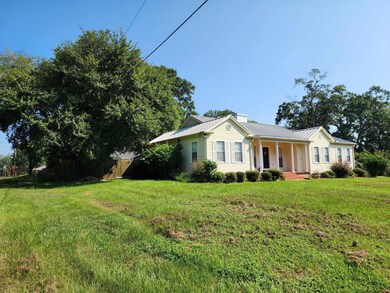Ranch-style house featuring a front lawn