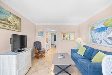 Living room featuring light tile floors, baseboard