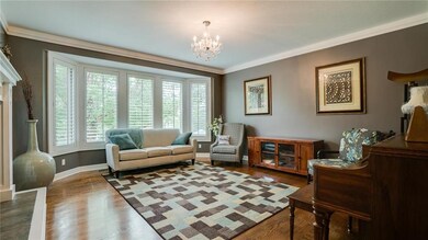 The formal living room features another large bay 
