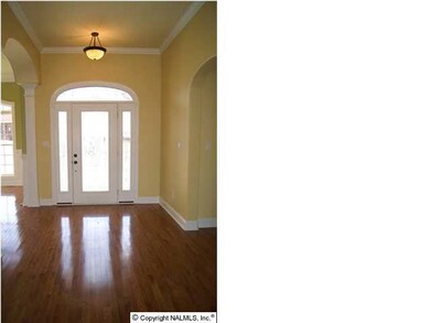 Foyer with beautiful chandelier and hardwood floors greet you at the front door.