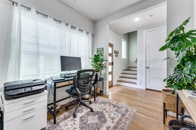 Home office with light wood-style floors and recessed lighting