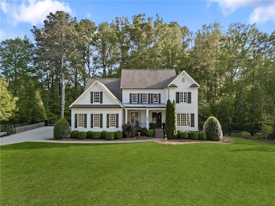 View of front facade featuring a porch, fence, a s