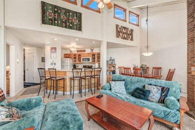 Living room featuring ceiling fan, beamed ceiling,