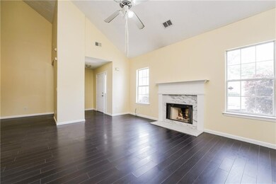 Unfurnished living room with a fireplace, a ceiling fan, baseboards, dark wood-style floors, and high vaulted ceiling