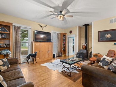 Living room with light hardwood / wood-style floor