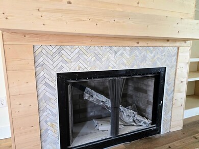 Detailed view of a fireplace and wood finished floors