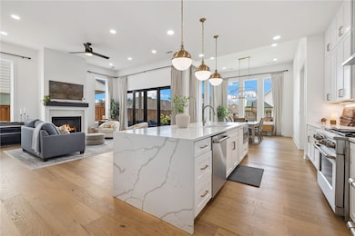 Open-concept kitchen/den/dining area.