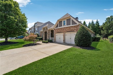 View of front of home with a front yard, brick siding, concrete driveway, a garage, and a chimney