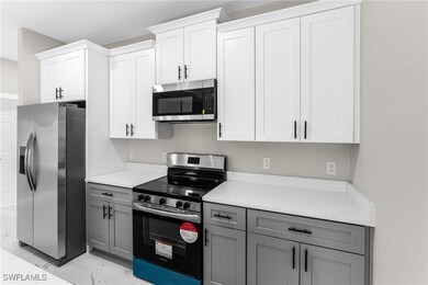 Kitchen featuring white cabinets, stainless steel