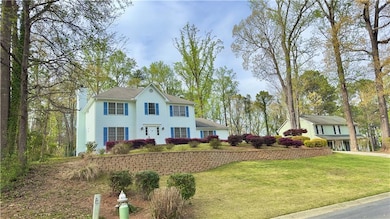 View of front of home with a front lawn and a chim