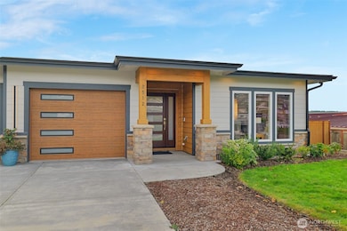A wide driveway and welcoming entry complement the easy-maintenance front yard, complete with an automated sprinkler system.