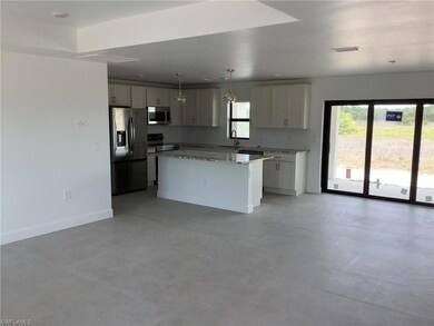 Kitchen with stainless steel appliances, a sink, plenty of natural light, and a kitchen island