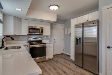 Beautiful updated kitchen with new countertops and bright white cabinetry. 