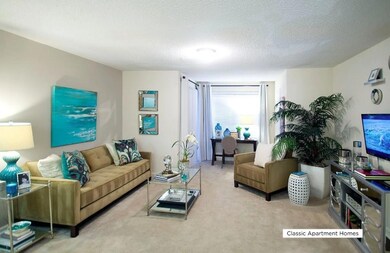 Living area featuring carpet floors and a textured ceiling