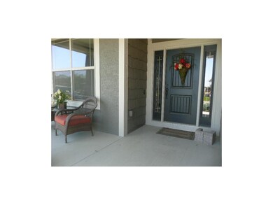 Oversized, covered, front porch provides a welcomi