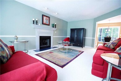 Kitchen is open to the family room which is punctuated by chair rail, dental molding around the mantle, & a gas fireplace enhanced with focus lights